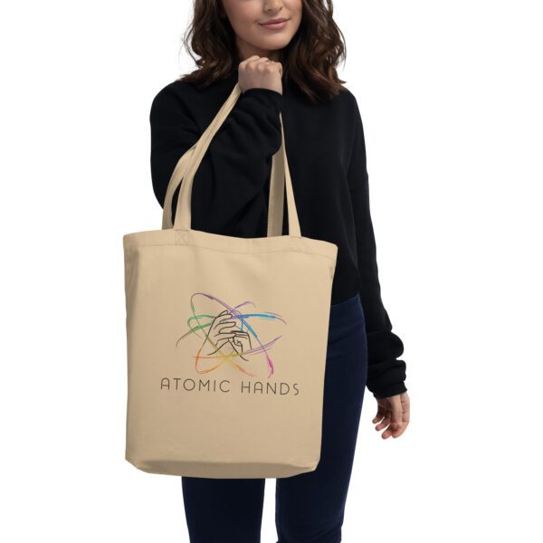 Woman holding oyster tote bag with logo