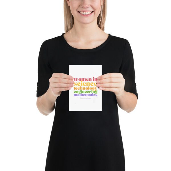 Female model holding a poster that says "women in science, technology, engineering, mathematics" with logo.