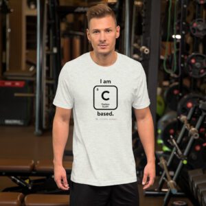 Male model in the gym wearing ash "I am Carbon (as an element) Based" shirt. Atomic Hands logo on the bottom.
