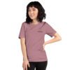 Female model wearing orchid shirt with "technology" and an illustration of how to sign technology is on the upper left chest