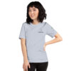 Female model wearing light blue shirt with "technology" and an illustration of how to sign technology is on the upper left chest