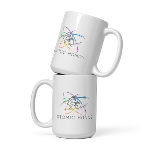 White mugs stacked on top with logo