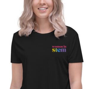 Close up of a female model with blond hair wearing a black crop tee with embroidered "women in stem"
