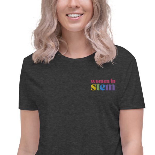 Close up of a female model with blond hair wearing a grey crop tee with embroidered "women in stem"