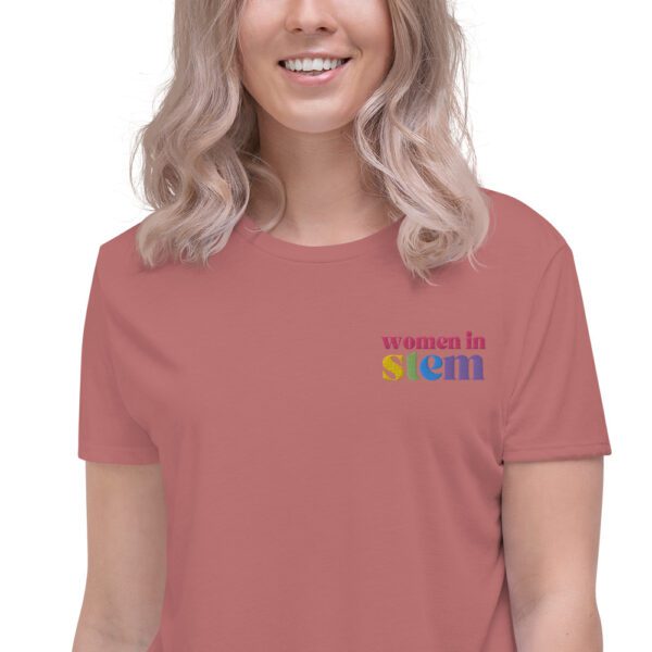Close up of a female model with blond hair wearing a mauve crop tee with embroidered "women in stem"