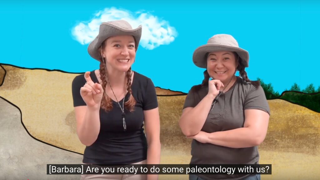 Barbara and Alicia smiling to the camera with paleontology background